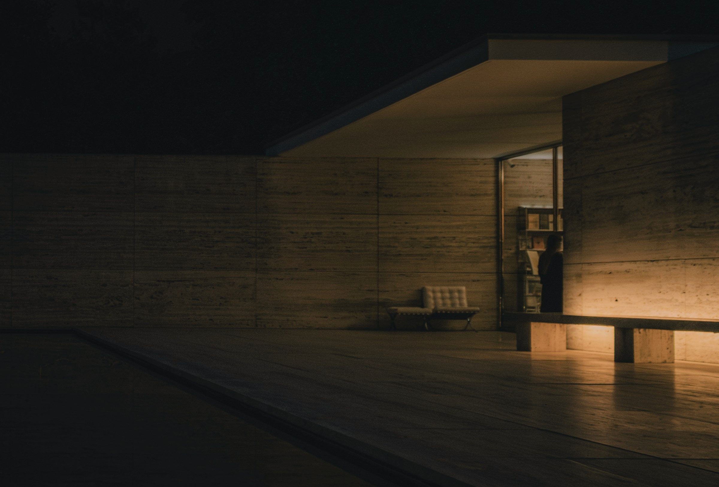 A stone pavilion softly lit at night